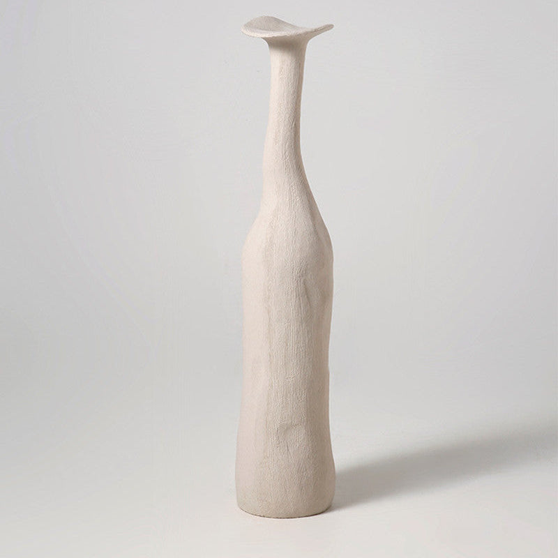 A beige ceramic vase with a minimalist design, featuring a smooth surface and a cut-out at the top.